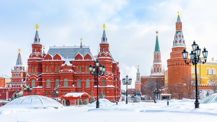 Moscow in winter, Russia. Manezhnaya Square overlooking Moscow Kremlin, top landmark of city. Panorama of Moscow center during snowfall. Scenery of old Moscow buildings under snow.