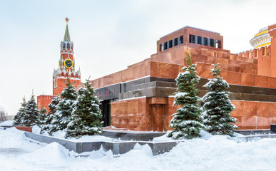 Moscow Red Square in winter, Russia. Lenin's Mausoleum by Moscow Kremlin under snow. This place is a famous tourist attraction of Moscow. The inscription is Lenin. Center of Moscow during snowfall.