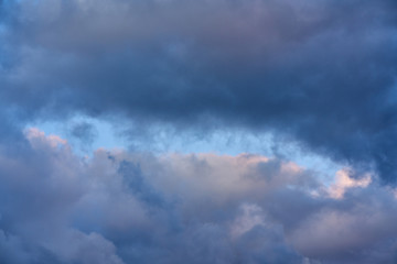Dark and formidable clouds and the sky is visible in the middle.