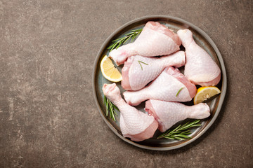 Fresh raw chicken legs with rosemary and lemon for cooking