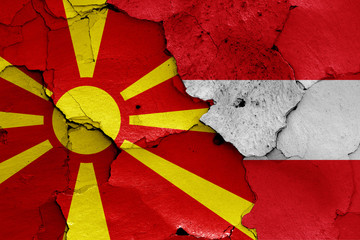 flags of North Macedonia and Austria painted on cracked wall