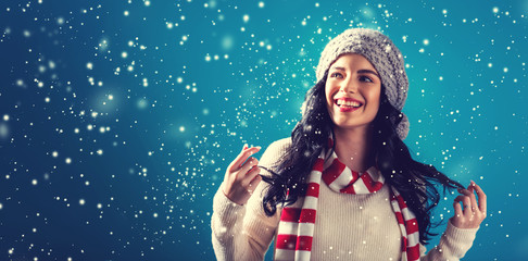 Happy young woman in winter clothes in a snowy night