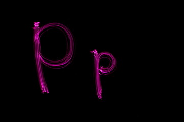 Long exposure photograph of  the letter p in pink neon color, in upper case and lower case, parallel lines pattern against a black background. Light painting photography.