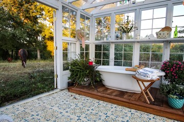 Beautiful Victorian Style Greenhouse built of  old recycled windows with a decorated interior with...