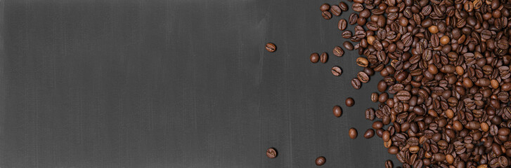 Coffee beans on black handmade painted background. Top view, Flat lay.