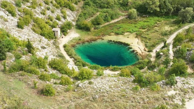 Croatia, Cetina river source water hole in Dalmatian Zagora, aerial drone view