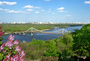 Fototapeta premium Kiev. Ukraine. View of the Dnieper River and the pedestrian bridge over the river.