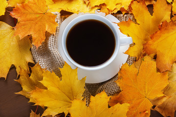  Autumn, fall leaves, hot cup of coffee and a warm scarf on wooden table background
