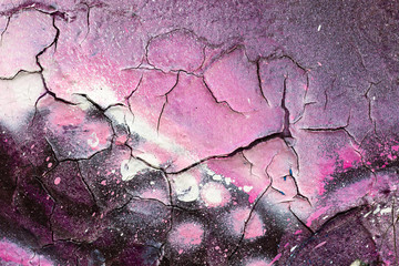 Surface texture with violet and pink color and many cracks on concrete wall. For abstract backgrounds.