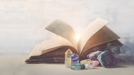 mystical composition with  minerals and crystals and ancient book. study of properties of minerals...