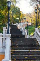 Autumn sunny day, steps of stairs in the old park, many fallen foliage. Seasons.