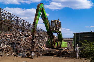  Dnipro, Dnepropetrovsk region / Ukraine - 01/10/2019; Loading scrap metal into wagons with a hydraulic manipulator.