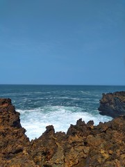 Fototapeta na wymiar View of Blue Sea, Coral Reefs, and Rock at Southern Sea of ​​Indonesia