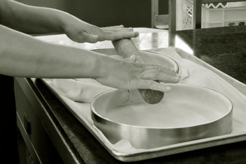 Closeup of hands preparing form to make pie