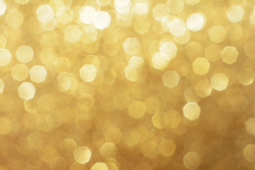Gold shimmering blurry background with copy space for poster or christmas card