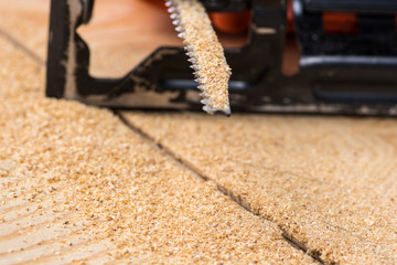 jigsaw saw a sheet of plywood or wood, prongs close-up macro