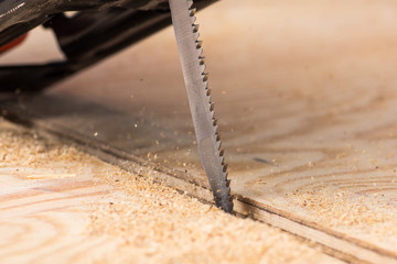 jigsaw saw a sheet of plywood or wood, prongs close-up macro