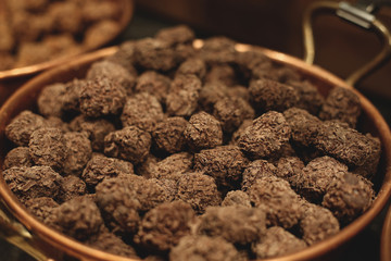 A bowl full of brown belgian patisserie pralines
