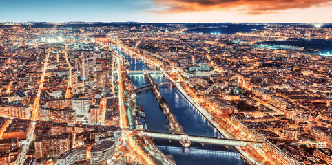 Paris city skyline rooftop view with River Seine at night, France. Evening panorama.