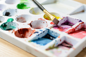 Close up Palette with color and paintbrush