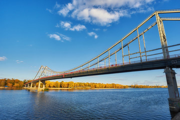 Pedestrian bridge across the Dnieper River, autumn landscape, Kiev
