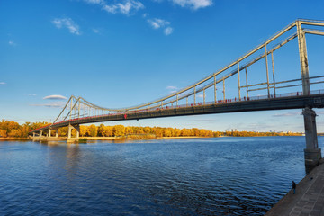 Fototapeta na wymiar Pedestrian bridge across the Dnieper River, autumn landscape, Kiev