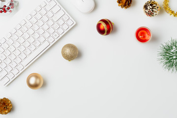 Flat lay top view office table desk, Christmas workspace with keyboard and christmas balls and other decorations on white background