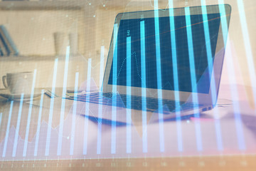 Forex Chart hologram on table with computer background. Multi exposure. Concept of financial markets.