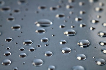 Perfectly shaped water drops on transparent plastic