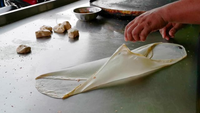 Clips of Roti Parata or Roti canai in the making process.