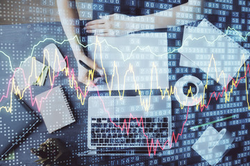 Financial graph displayed on woman's hand taking notes background. Concept of research. Multi exposure