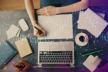 Financial graph displayed on woman's hand taking notes background. Concept of research. Multi exposure