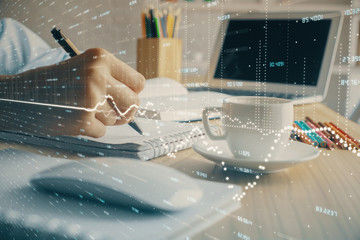 Financial chart drawn over hands taking notes background. Concept of research. Double exposure