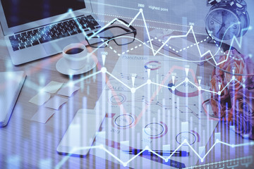 Forex market graph hologram and personal computer on background. Double exposure. Concept of investment.