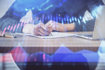 Double exposure hands with stock market chart.