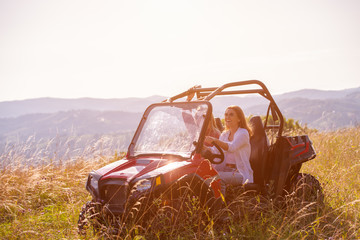 two young women driving a off road buggy car © .shock
