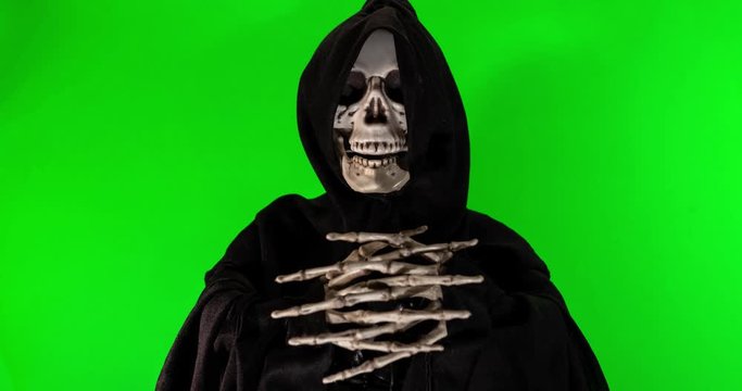 Talking skeleton with black scarf stop motion footage on a green background with alpha channel.