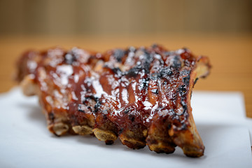 Rack of cooked sticky bbq ribs with copy space.