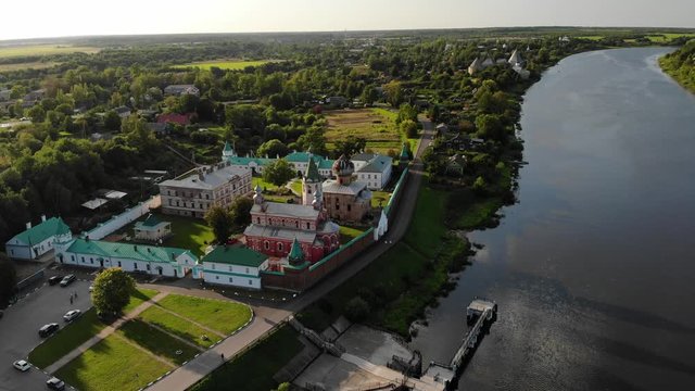 flying over monastery of Ladoga near Volkhov river Volhov. Red walls. Russia. Orthodoxy Church.  Touristic place. Leningrad region Leningradskaya. Aerial view 