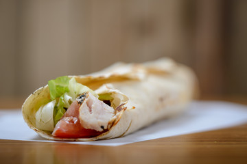 Close up of chicken and salad wrap with selective focus