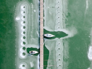Boats frozen in the water on lake Balaton, Hungary