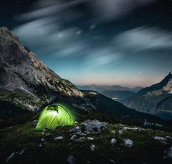 Lit up Tent at night in the Mountains