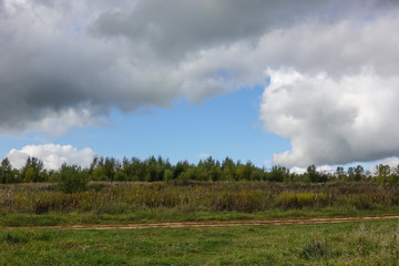 Storm clouds in the sky. Clearance in the clouds through which the blue sky is visible