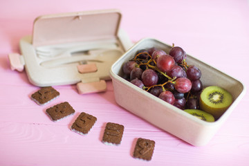 Healthy lunch to go. Fruits and vegetables packed in lunch box. Healthy eating concept. View from above with copy space.