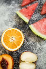 Watermelon slice on wooden cutting board summer fruit. Bananas and nictarin with apple on table. Healthy fruits. Sport eat and dieting.