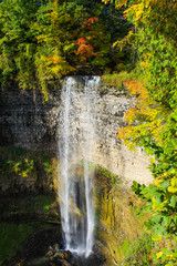 Waterfall in autumn landscape