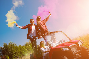 group of young people having fun while driving a off road buggy car