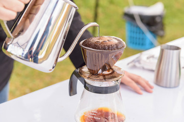 Pouring hot water on ground coffee, hand drip coffee
