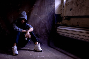 Woman sitting on the floor with substance abuse, substance abuse, addiction, people and drug use concept.