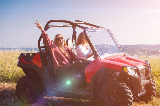 two young women driving a off road buggy car